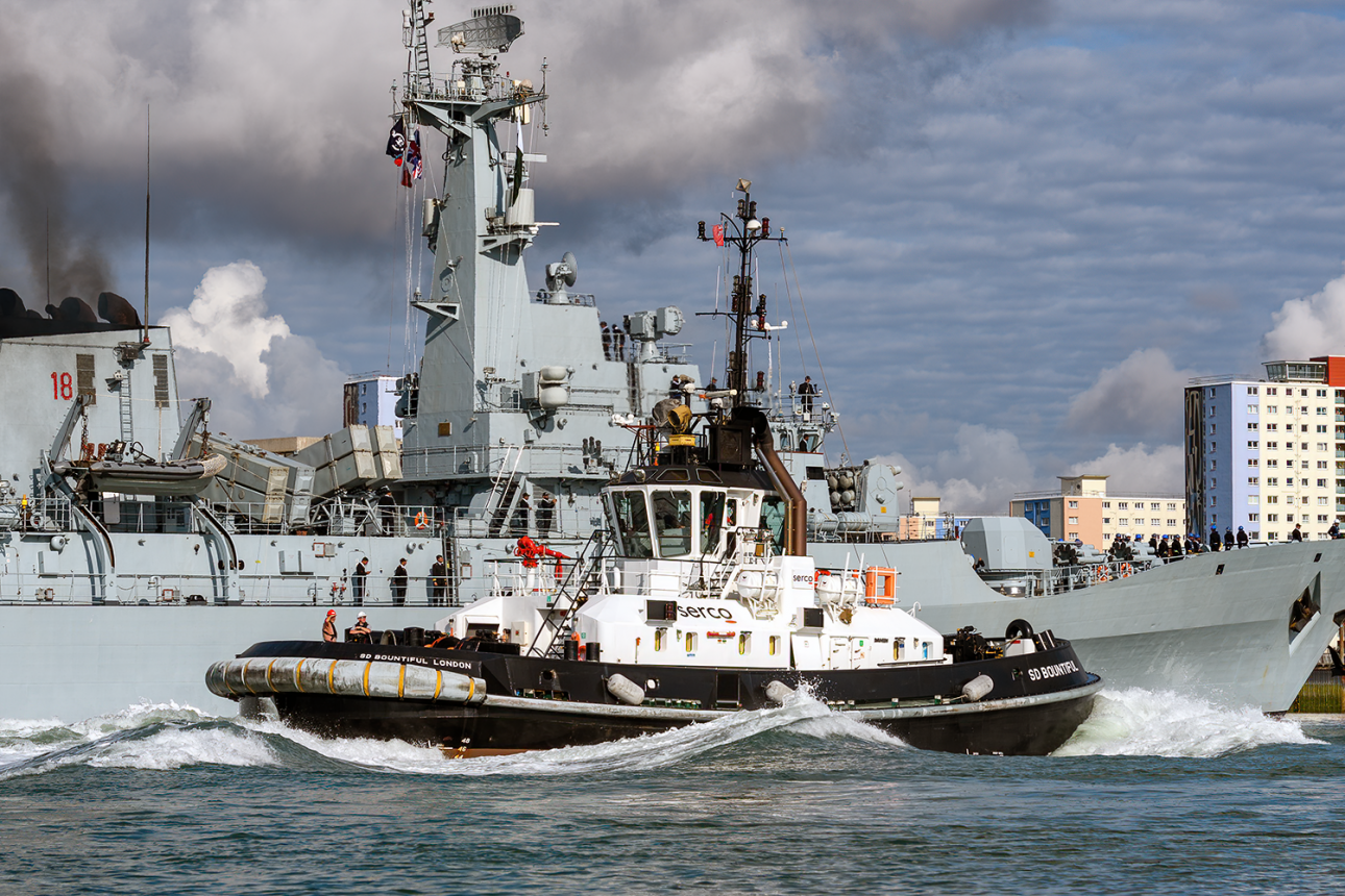 The Serco Marine naval tug SD Bountiful assisting a warship at Portsmouth.